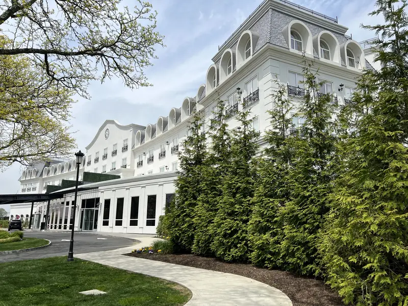 The Chateau Grande Hotel, East Brunswick, NJ: French chateau-style hotel with mansard dormers, a lamp post and a curving front walk