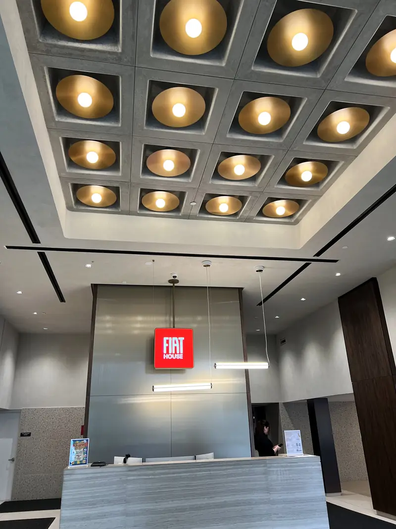 FIAT House Lobby, Fort Lee, NJ: coffered ceiling of gold dome downlights and linear pendants above the reception desk