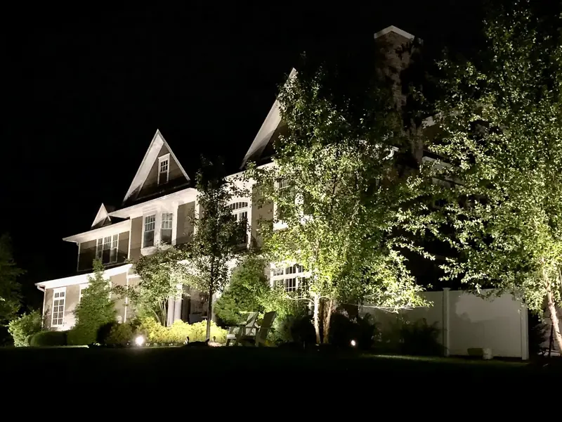 Home Facade, Florham Park, NJ: front facade uplighting on trees and a two-story home at night