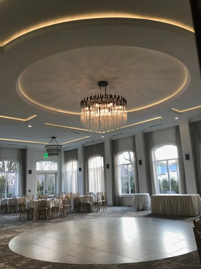 party room with a cove-lit round ceiling and chandelier, The Chateau Grande Hotel