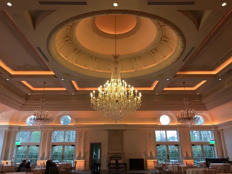 Park Chateau, Catering Hall, East Brunswick, NJ: ballroom with warm cove-lit coffered ceiling and chandeliers