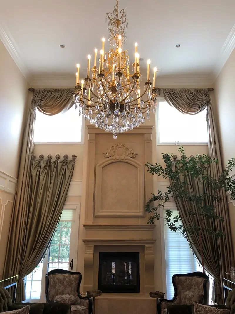 Residence, Upper Saddle River, NJ: double-height living room with a crystal chandelier and fireplace